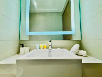 a bathroom with a sink and a mirror at Venduras - Skyline View Farhad Azizi Residence Al Jaddaf in Dubai