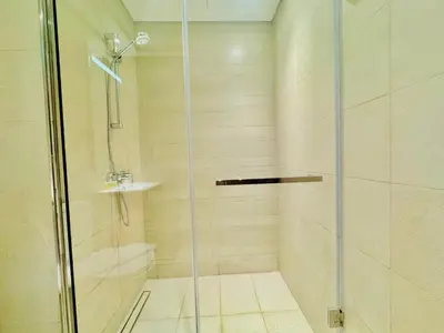 a bathroom with a shower with a glass door at Venduras - Skyline View Farhad Azizi Residence Al Jaddaf in Dubai