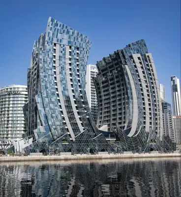 two tall buildings next to a body of water at Daniels Canal View 1BR at J One Business Bay in Dubai