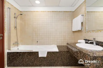 a bathroom with a bath tub and a sink at Dream Inn Apartments - Sadaf Residence JBR in Dubai