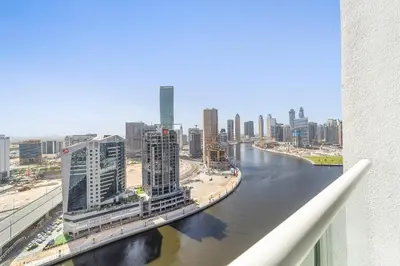 a view of a river in a city with buildings at Elegant 1BR - Spacious & Luxury - Canal View in Dubai