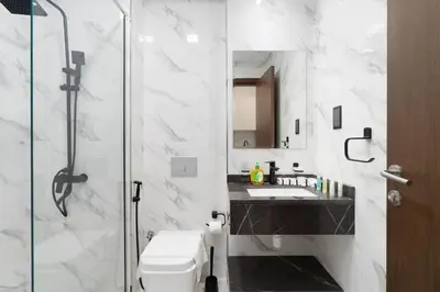 a bathroom with a shower and a toilet and a sink at Nice and cozy Studio Elysée 2 in JVC - Dubai in Dubai
