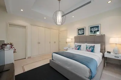 a large bedroom with a large bed and a television at Maison Privee - Exclusive Villa with Private Pool, Garden & Beach in Dubai