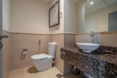 a bathroom with a white toilet and a sink at GuestReady - Modern and luxe near JBR Beach in Dubai