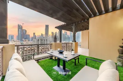 a view of the city from the balcony of a building at Manzil - Cozy 2BR Penthouse with Private Terrace and Full Burj View in Downtown in Dubai