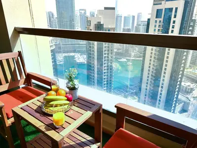 a table with a bowl of fruit on a balcony at Luxury Casa - Indigo Sea View Apartment JBR Beach 2BR in Dubai