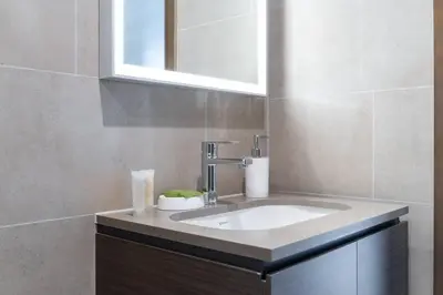 a bathroom with a sink and a mirror at Intimate Apartment with Scenic View of Dubai Creek in Dubai