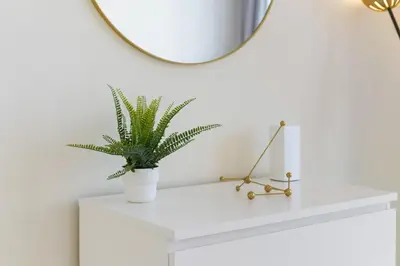 a plant on a white shelf with a mirror at Impressive View 2BR in Dubai Marina Walk2Beach in Dubai