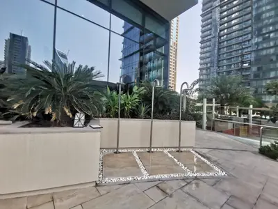 a courtyard in a city with tall buildings at Vacay Lettings - Suite room in Marina gate, Jumeirah living in Dubai