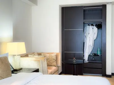 a living room with a bed and a couch at Scenic view studio/Dubai Marina in Dubai