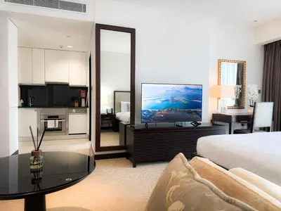 a hotel room with a bed and a television at Scenic view studio/Dubai Marina in Dubai