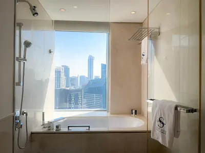 a bathroom with a bath tub and a window at Scenic view studio/Dubai Marina in Dubai