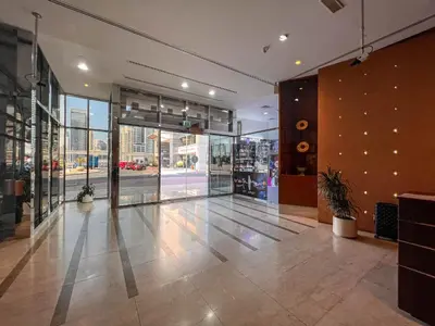 an empty lobby of a store with a large glass door at Cosmos Living Cozy Studio Near Dubai Marina in Dubai