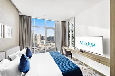 a hotel room with a bed and a tv at ALiving Modern Studio I Canal View I DAMAC Maison Prive A- 1102 in Dubai