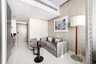 a living room with a couch and a table at ALiving Modern Studio I Canal View I DAMAC Maison Prive A- 1102 in Dubai