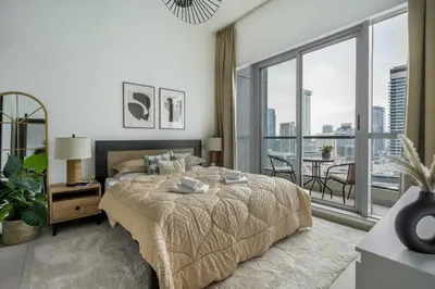 a bedroom with a large bed and a large window at GuestReady - Exquisite getaway with Marina views in Dubai