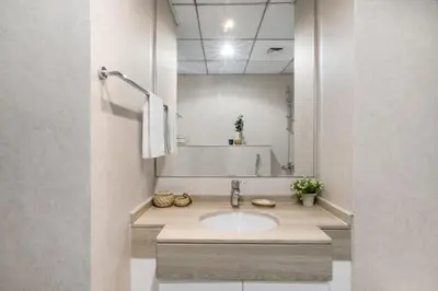 a bathroom with a sink and a mirror at GuestReady - Exquisite getaway with Marina views in Dubai