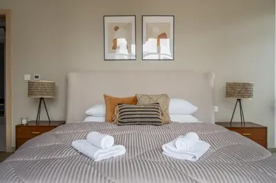 a bedroom with a bed with two towels on it at GuestReady - Luxurious Accents near Burj Khalifa in Dubai