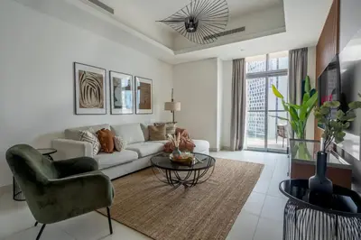 a living room with a couch and a table at GuestReady - Luxurious Accents near Burj Khalifa in Dubai