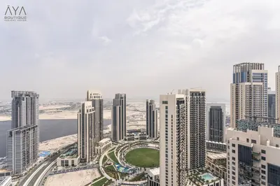an aerial view of a city with tall buildings at Elegant Luxury Apartment with Stunning Lake Views in Dubai Creek Harbour By ĀYA Boutique in Dubai
