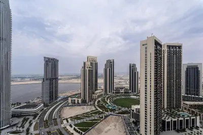 an aerial view of a city with tall buildings at Elegant Luxury Apartment with Stunning Lake Views in Dubai Creek Harbour By ĀYA Boutique in Dubai