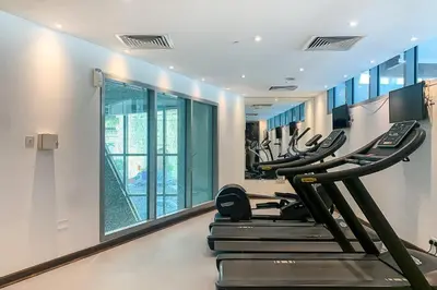 a gym with several treadmills in a room at Frank Porter - The Jwls T2 in Dubai