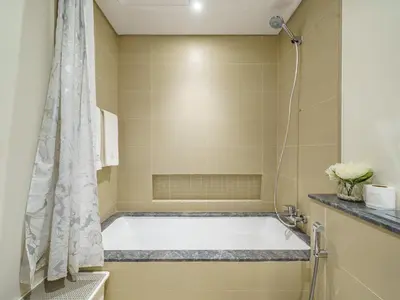 a bathroom with a tub and a shower at Marvelous 1BR with Beautiful Marina View in Dubai