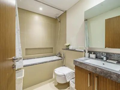 a bathroom with a toilet and a sink and a tub at Marvelous 1BR with Beautiful Marina View in Dubai