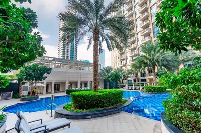 a courtyard with a palm tree and a building at Captivating Arabian Sea & Burj Khalifa Views in Dubai