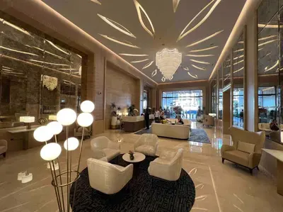 a lobby with a large chandelier in a building at Palm Tower St. Regis Amazing view high-end Studio in Dubai