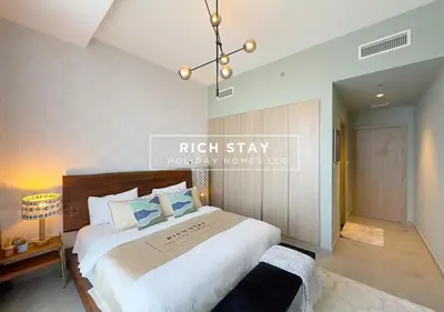 a bedroom with a large white bed in a room at Grande 3BR in Stella Maris, Sea View, Dubai Marina in Dubai