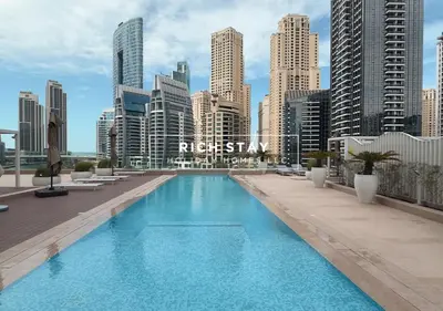 a large swimming pool on top of a city skyline at Grande 3BR in Stella Maris, Sea View, Dubai Marina in Dubai