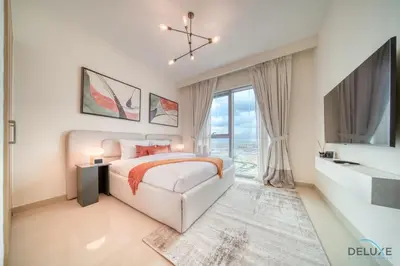a white bedroom with a bed and a large window at Elegant 1BR at Harbour Views Tower 1 by Deluxe Holiday Homes in Dubai