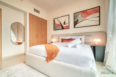 a bedroom with a large white bed and a mirror at Elegant 1BR at Harbour Views Tower 1 by Deluxe Holiday Homes in Dubai