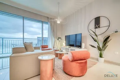 a living room with a couch and chairs and a tv at Alluring 1BR at Harbour Views Tower 1 by Deluxe Holiday Homes in Dubai