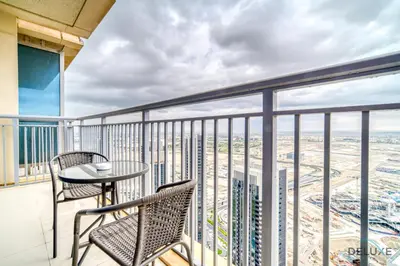 a balcony with a table and chairs on a building at Alluring 1BR at Harbour Views Tower 1 by Deluxe Holiday Homes in Dubai