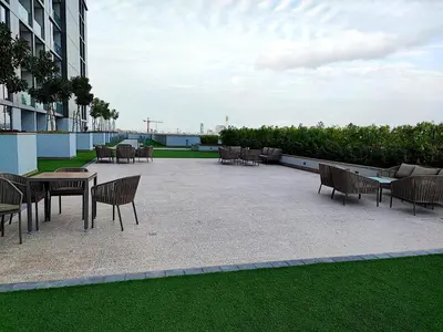 a patio with tables and chairs in a building at Perfect 1 BR for Family Stay - Close to Downtown in Dubai