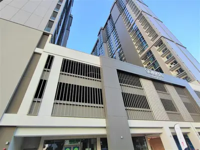 a building in front of some tall buildings at Perfect 1 BR for Family Stay - Close to Downtown in Dubai