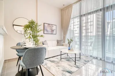 a living room with a white couch and a table at Soothing 1BR at Merano Business Bay by Deluxe Holiday Homes in Dubai