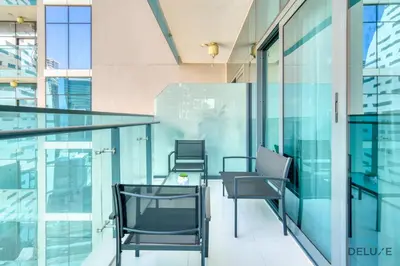 a group of chairs sitting on a balcony in a building at Soothing 1BR at Merano Business Bay by Deluxe Holiday Homes in Dubai