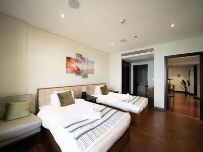 a hotel room with two beds and a couch at Luxury Anantara Res - Sea & Burj AlArab View in Dubai