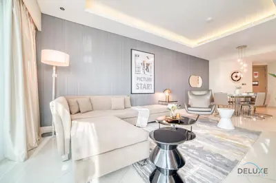a living room with a couch and a table at Polished 3BR at DAMAC Towers by Paramount A Business Bay by Deluxe Holiday Homes in Dubai