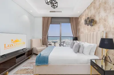 a bedroom with a large bed and a television at LuxBnB Paramount Midtown SeaView in Dubai