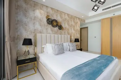 a bedroom with a large white bed and a wall at LuxBnB Paramount Midtown SeaView in Dubai