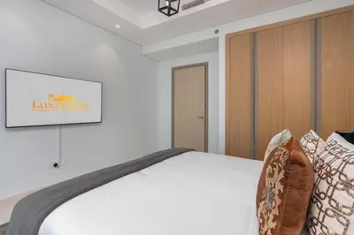 a bedroom with a bed with a sign on the wall at LuxBnB Paramount Midtown SeaView in Dubai