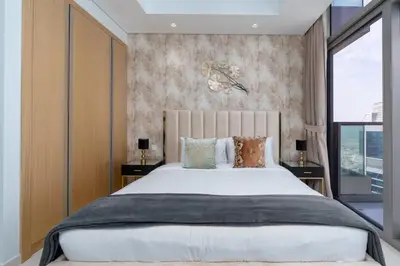 a bedroom with a large bed and a large window at LuxBnB Paramount Midtown SeaView in Dubai