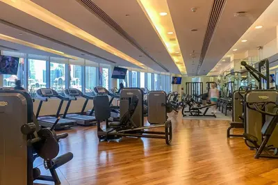 a gym with lots of treadmills and exercise bikes at Frank Porter - Emaar Residences Fashion Avenue in Dubai