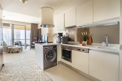 a kitchen with a washing machine in the middle at Frank Porter - Emaar Residences Fashion Avenue in Dubai