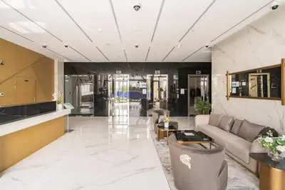 a living room with a couch and a table at Luxurious 1-bedroom apartment in Dubai Hills in Dubai