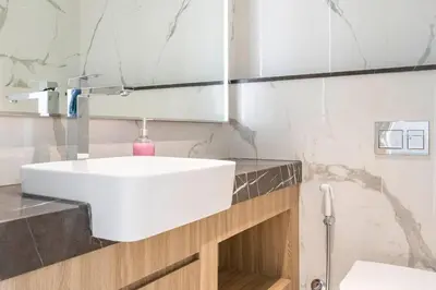 a bathroom with a white sink and a mirror at Luxurious 1-bedroom apartment in Dubai Hills in Dubai